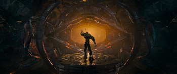 Movie still from “Transformers: Rise of the Beasts” (2023), directed by Steven Caple Jr. – An image of a man standing in the middle of a tunnel; Extreme Wide shot, Low angle