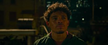 Movie still from “Transformers: Rise of the Beasts” (2023), directed by Steven Caple Jr. – A person with curly hair; Close Up shot, Over the shoulder angle