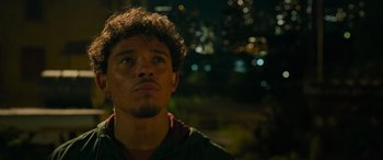 Movie still from “Transformers: Rise of the Beasts” (2023), directed by Steven Caple Jr. – A young man is looking into the distance at night; Close Up shot, Over the shoulder angle