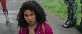 Movie still from “Transformers: Rise of the Beasts” (2023), directed by Steven Caple Jr. – A person wearing a jacket; Close Up shot, Over the shoulder angle