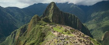 Movie still from “Transformers: Rise of the Beasts” (2023), directed by Steven Caple Jr. – A view of the mountains from the top of a mountain; Extreme Wide shot, High angle