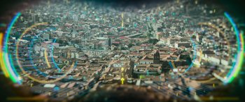 Movie still from “Transformers: Rise of the Beasts” (2023), directed by Steven Caple Jr. – An aerial view of a large city with many buildings; Extreme Wide shot, High angle