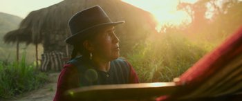 Movie still from “Transformers: Rise of the Beasts” (2023), directed by Steven Caple Jr. – A woman wearing a hat looking into the distance; Close Up shot, Over the shoulder angle