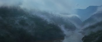 Movie still from “Transformers: Rise of the Beasts” (2023), directed by Steven Caple Jr. – A large body of water surrounded by dense fog; Extreme Wide shot, High angle