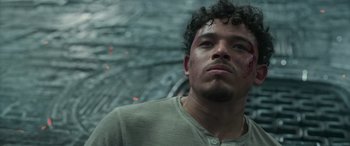 Movie still from “Transformers: Rise of the Beasts” (2023), directed by Steven Caple Jr. – A person wearing a green shirt; Close Up shot, Low angle