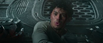 Movie still from “Transformers: Rise of the Beasts” (2023), directed by Steven Caple Jr. – A person with a beard; Close Up shot, Low angle