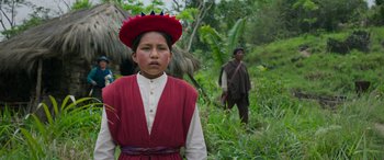 Movie still from “Transformers: Rise of the Beasts” (2023), directed by Steven Caple Jr. – A young boy wearing a red hat in the woods; Medium shot, Over the shoulder angle