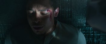 Movie still from “Transformers: Rise of the Beasts” (2023), directed by Steven Caple Jr. – A person with blood on his face; Close Up shot, Overhead angle