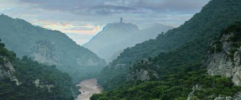 Movie still from “Transformers: Rise of the Beasts” (2023), directed by Steven Caple Jr. – A view of a valley with a mountain in the background; Extreme Wide shot, Low angle