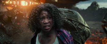 Movie still from “Transformers: Rise of the Beasts” (2023), directed by Steven Caple Jr. – A person with a broken arm; Close Up shot, Over the shoulder angle