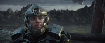 Movie still from “Transformers: Rise of the Beasts” (2023), directed by Steven Caple Jr. – A person wearing a helmet; Close Up shot, Low angle