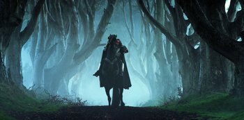 Movie still from “Transformers: The Last Knight” (2017), directed by Michael Bay – A man riding a horse through a forest; Wide shot, Low angle