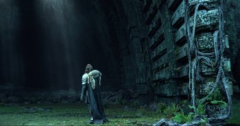 Movie still from “Transformers: The Last Knight” (2017), directed by Michael Bay – A man in a suit of armor is standing in front of a wall; Wide shot, Low angle