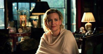 Movie still from “Transformers: The Last Knight” (2017), directed by Michael Bay – A woman sitting in a chair wearing a white sweater; Close Up shot, Over the shoulder angle