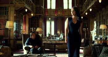 Movie still from “Transformers: The Last Knight” (2017), directed by Michael Bay – A woman in a black dress standing in front of a man in a black dress; Wide shot, Low angle