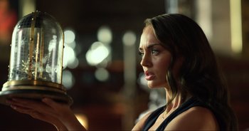 Movie still from “Transformers: The Last Knight” (2017), directed by Michael Bay – A beautiful woman holding a mirror in front of a blurry background; Close Up shot, Low angle