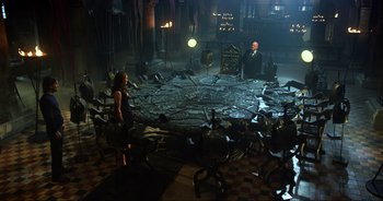 Movie still from “Transformers: The Last Knight” (2017), directed by Michael Bay – A group of people sitting in a circle of chairs; Wide shot, High angle