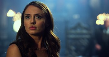 Movie still from “Transformers: The Last Knight” (2017), directed by Michael Bay – A beautiful woman with long brown hair looking up at the sky; Close Up shot, Over the shoulder angle