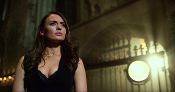 Movie still from “Transformers: The Last Knight” (2017), directed by Michael Bay – A woman in a black dress looking up at the sky; Close Up shot, Low angle