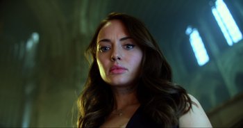 Movie still from “Transformers: The Last Knight” (2017), directed by Michael Bay – A woman with long brown hair wearing a black top; Close Up shot, Low angle
