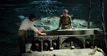 Movie still from “Transformers: The Last Knight” (2017), directed by Michael Bay – A man and a woman working together on a building project; Wide shot, Over the shoulder angle