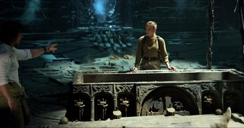 Movie still from “Transformers: The Last Knight” (2017), directed by Michael Bay – A man standing in front of an old stone structure; Wide shot, High angle