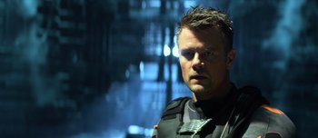 Movie still from “Transformers: The Last Knight” (2017), directed by Michael Bay – A person wearing a uniform; Close Up shot, Over the shoulder angle