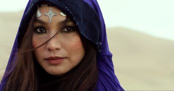 Movie still from “Transformers: The Last Knight” (2017), directed by Michael Bay – A woman in a purple dress with a cross on her head; Close Up shot, Low angle