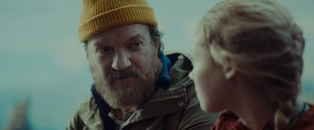 Movie still from “Troll” (2022), directed by Roar Uthaug – An older man and a young boy are talking to each other; Close Up shot, Over the shoulder angle