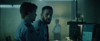 Movie still from “Troll” (2022), directed by Roar Uthaug – A man with a beard is looking at a mirror; Medium shot, Low angle