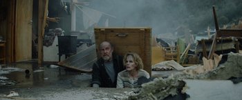 Movie still from “Troll” (2022), directed by Roar Uthaug – A man and a woman sitting next to each other; Medium shot, High angle