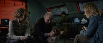 Movie still from “Troll” (2022), directed by Roar Uthaug – An old man sitting in front of a cat; Medium shot, Over the shoulder angle