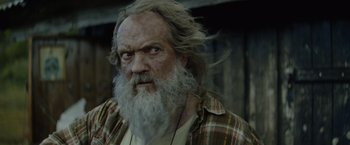 Movie still from “Troll” (2022), directed by Roar Uthaug – An old man with long white hair and a beard; Close Up shot, Low angle