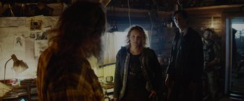 Movie still from “Troll” (2022), directed by Roar Uthaug – A woman standing next to a man in a room; Medium shot, Over the shoulder angle