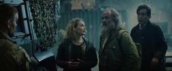 Movie still from “Troll” (2022), directed by Roar Uthaug – A man and a woman standing next to each other; Medium shot, Low angle