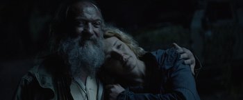 Movie still from “Troll” (2022), directed by Roar Uthaug – An older man and a younger woman pose for a picture; Close Up shot, Low angle