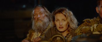 Movie still from “Troll” (2022), directed by Roar Uthaug – A man and a woman sitting next to each other; Close Up shot, Low angle