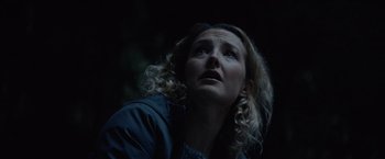 Movie still from “Troll” (2022), directed by Roar Uthaug – A person with curly hair looking up; Close Up shot, Low angle