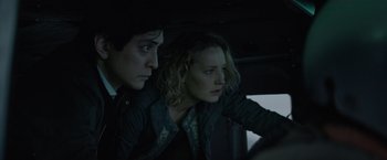 Movie still from “Troll” (2022), directed by Roar Uthaug – A man and a woman sitting in a car looking at something; Medium shot, Low angle