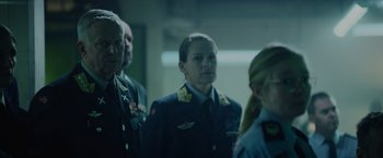 Movie still from “Troll” (2022), directed by Roar Uthaug – A group of people standing next to each other in a room; Medium shot, Over the shoulder angle