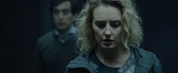 Movie still from “Troll” (2022), directed by Roar Uthaug – A person with curly blonde hair; Close Up shot, Over the shoulder angle