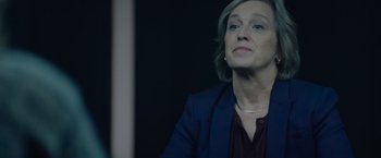 Movie still from “Troll” (2022), directed by Roar Uthaug – A woman in a blue jacket looking up at the sky; Close Up shot, Over the shoulder angle