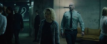 Movie still from “Troll” (2022), directed by Roar Uthaug – A man and a woman walking down a hall way; Medium shot, Low angle