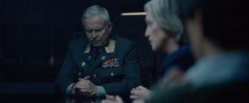 Movie still from “Troll” (2022), directed by Roar Uthaug – A man and a woman sitting in front of a table; Medium shot, Over the shoulder angle