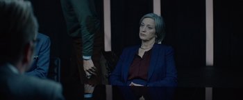 Movie still from “Troll” (2022), directed by Roar Uthaug – A woman sitting at a table in front of a man; Medium shot, Over the shoulder angle