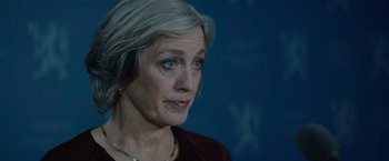Movie still from “Troll” (2022), directed by Roar Uthaug – An older woman with gray hair looking at the camera; Close Up shot, Over the shoulder angle