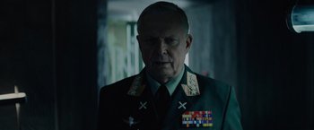 Movie still from “Troll” (2022), directed by Roar Uthaug – An older man wearing a military uniform and medals; Close Up shot, Over the shoulder angle