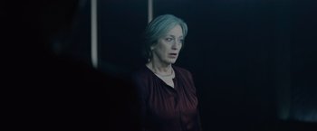 Movie still from “Troll” (2022), directed by Roar Uthaug – A woman with blue hair standing in front of a window; Close Up shot, Over the shoulder angle