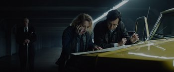 Movie still from “Troll” (2022), directed by Roar Uthaug – A man and a woman looking at a map; Medium shot, Low angle