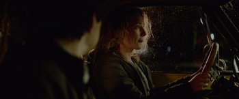 Movie still from “Troll” (2022), directed by Roar Uthaug – A woman sitting in a car looking out the window; Close Up shot, Over the shoulder angle